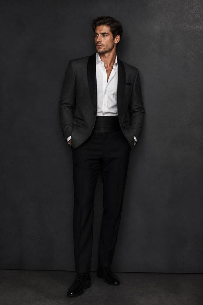 A charcoal dinner suit on a dress form
